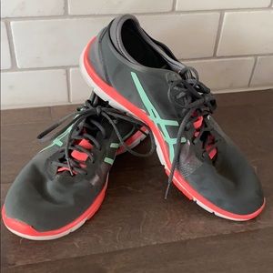 Gray ASICS sneakers with pink and green accents